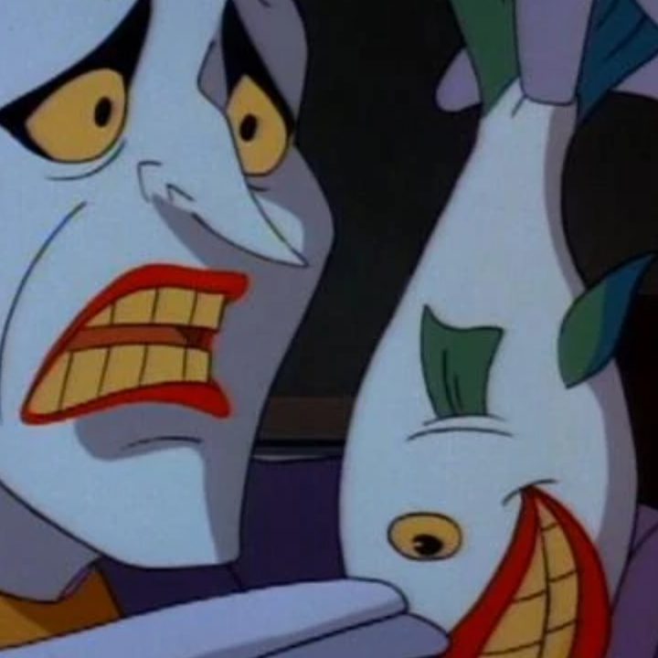 Joker holding up one of his titular laughing fish in BTAS.