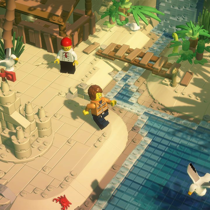 A lego man walks across a lego beach in Lego Bricktales.
