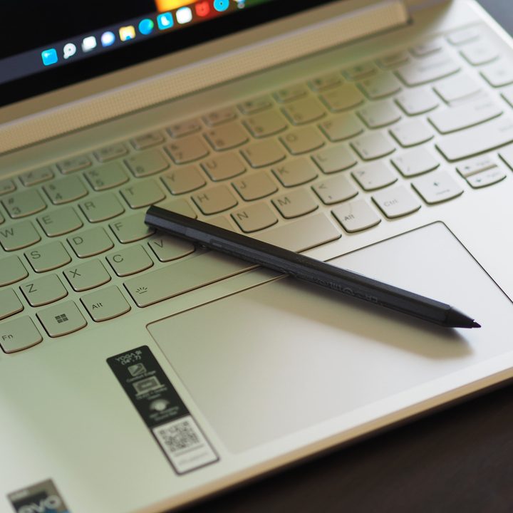 The Lenovo Yoga 9i 14 Gen 7 keyboard and stylus in a top-down view.