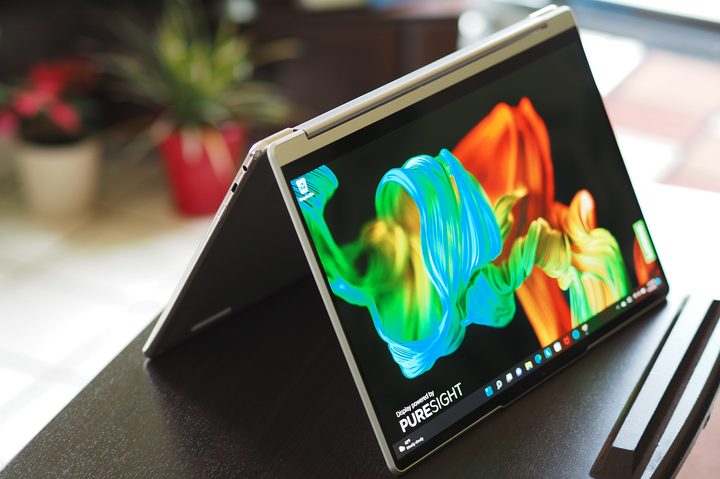 Lenovo Yoga 9i 14 Gen 7 laptop sits on a small desk folded like a tent.