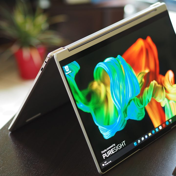 Lenovo Yoga 9i 14 Gen 7 laptop sits on a small desk folded like a tent.