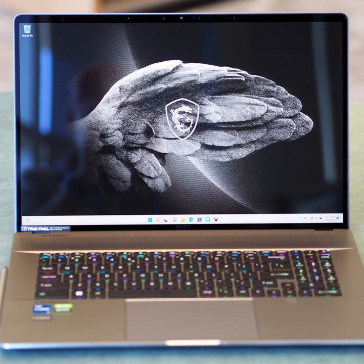 A MSI Creator Z17 laptop sitting on a green table.