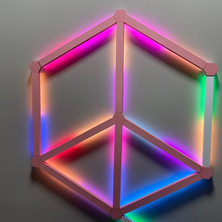 The Nanoleaf Lines with a pink skin and the lights turned on.