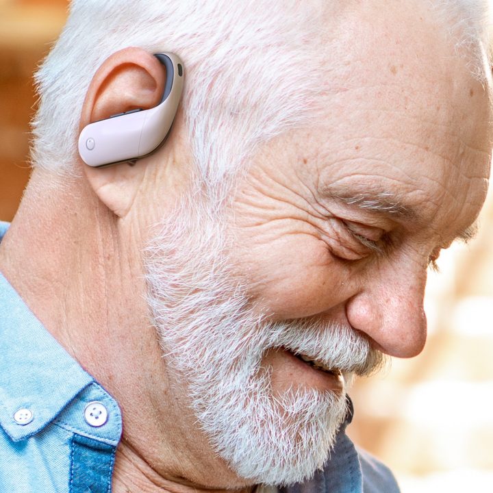 Man wearing Olive Max hearing aids.
