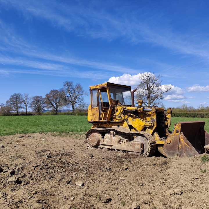 A digger in a field shot with the OnePlus 9 Pro main camera photo.