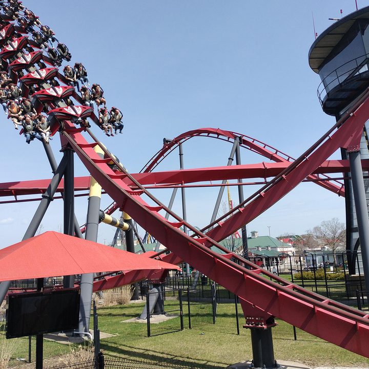 People ride on a roller coaster