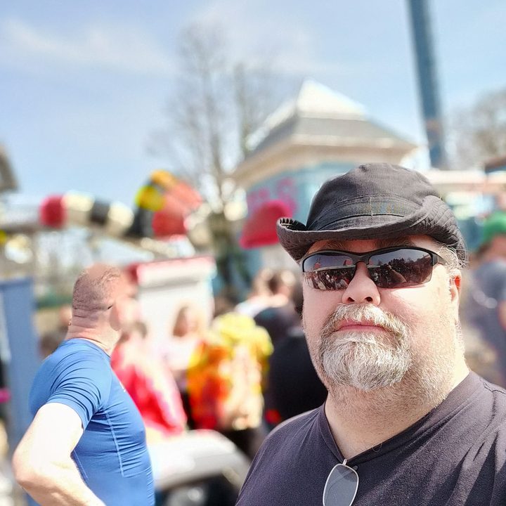 Selfie taken in portrait mode while waiting in line.