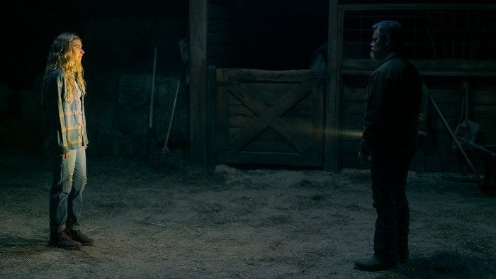 Imogen Poots stares at shadowed figured in a scene from Outer Range.