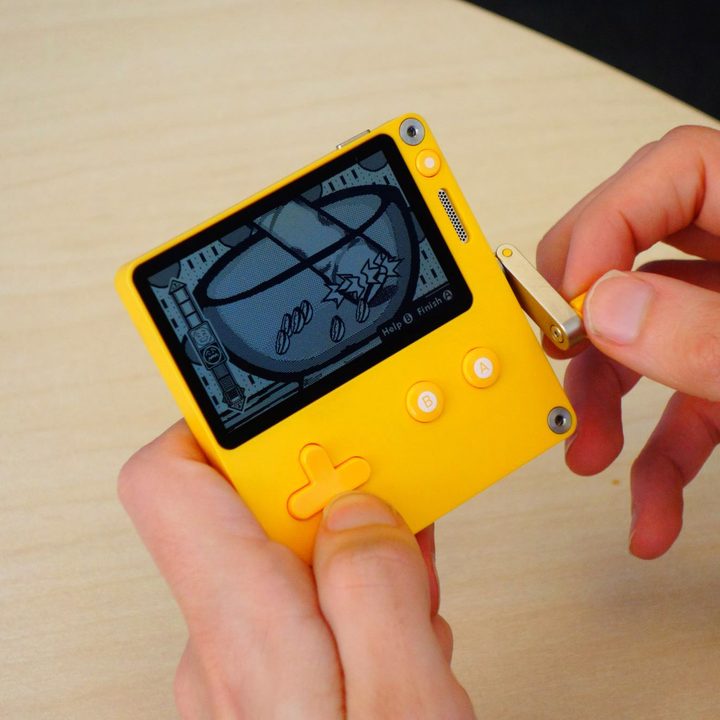 A gamer plays Spellcorked on the Playdate.