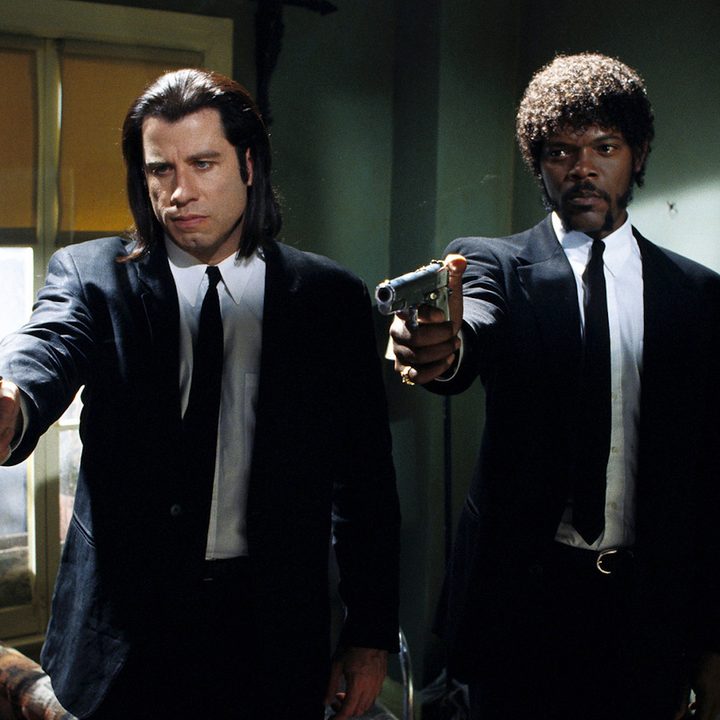 John Travolta and Samuel L. Jackson as Vincent Vega and Jules Winnfield aiming guns in the same direction in the film Pulp Fiction.