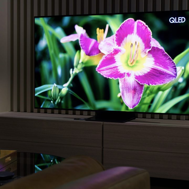 Samsung S95B OLED TV with image of a bright flower on screen.
