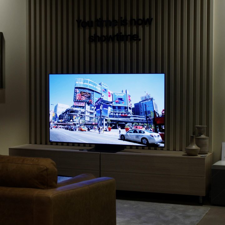 Samsung S95B OLED TV in living room setting.