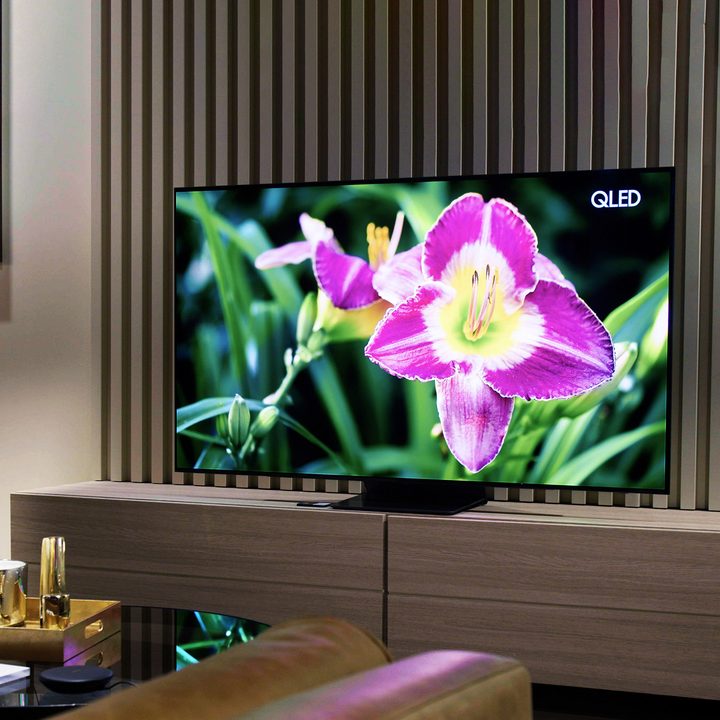 Samsung S95B OLED TV with image of a bright flower on screen.