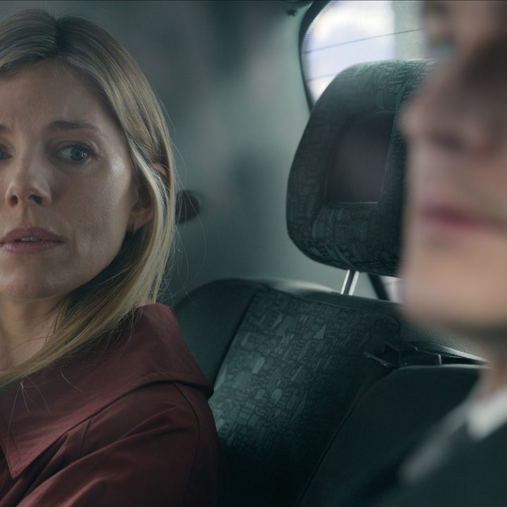Sienna Miller looks at Rupert Friend in the back of a car in Anatomy of a Scandal.