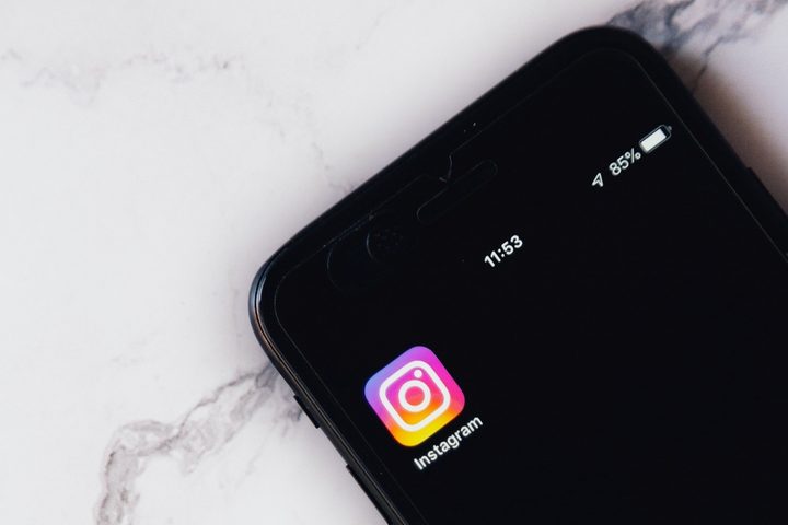 Turned on smartphone with Instagram app icon on its screen.