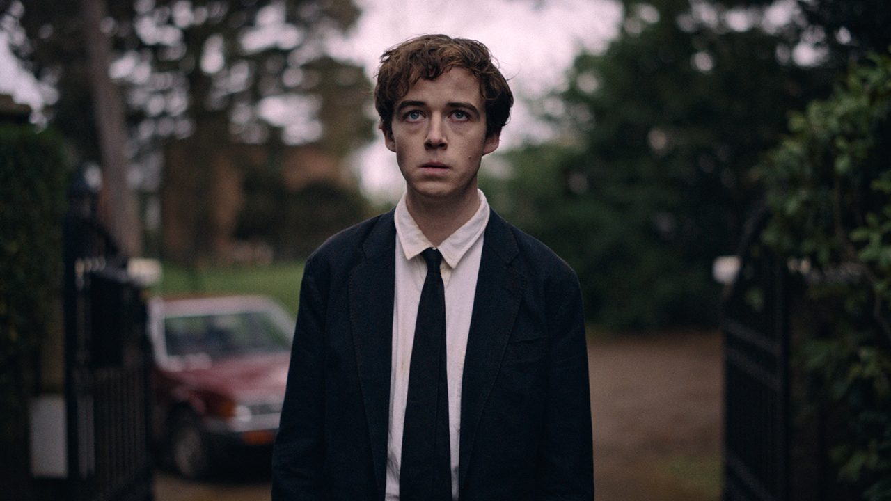 James from The End of the F**king World wearing a suit and tie and looking upset.