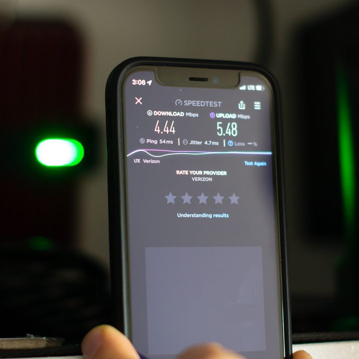 A closeup of a smartphone measuring a speed test in front of an RV cabinet