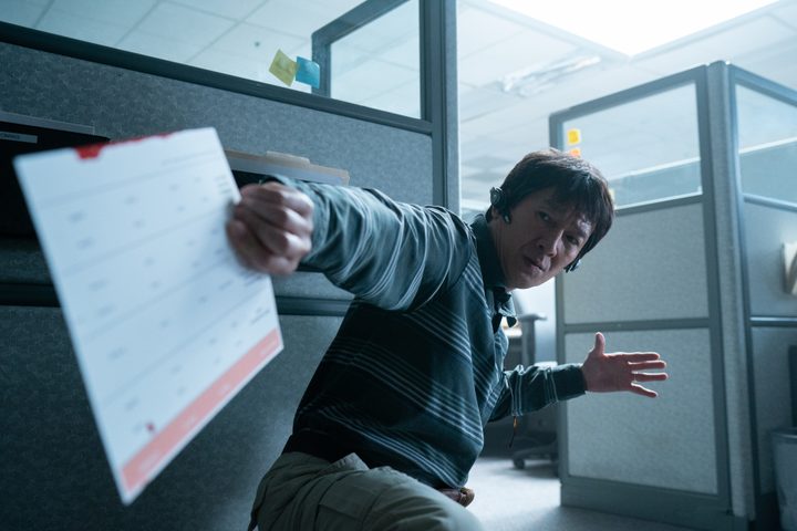 Waymond Wang holds a piece of paper in Everything Everywhere All at Once.