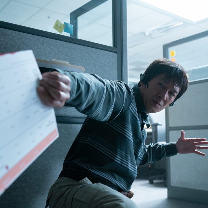Waymond Wang holds a piece of paper in Everything Everywhere All At Once.