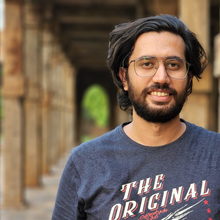 Unedited portrait shot of a man near the Indian monument Qutub Minar shot on the Samsung Galaxy S22 Ultra in JPEG.