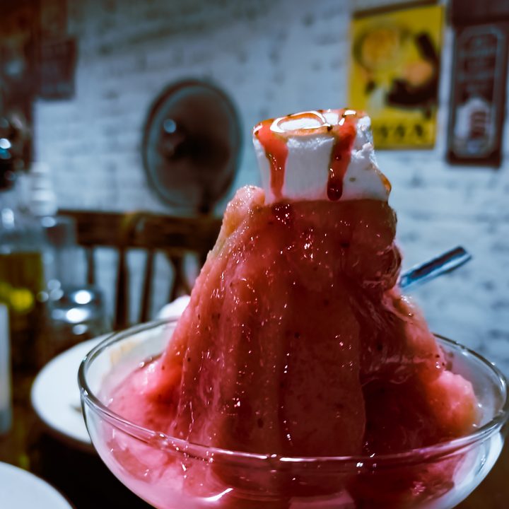 Edited image of bubblegum granita topped with mashmallow and syrup in a glass cup shot on the Samsung Galaxy S22 Ultra in RAW.