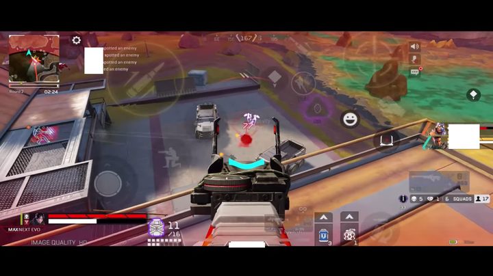 Shooting an SMG at an enemy below.