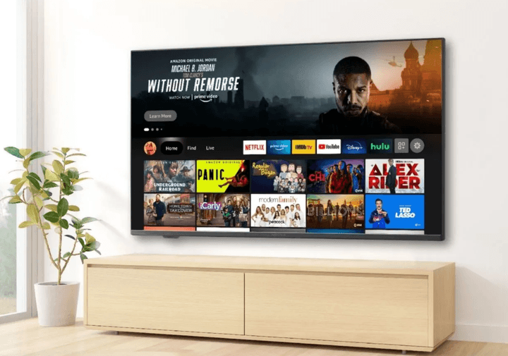 The Insignia F30 Series 4K TV mounted on a wall with the Fire TV interface on the screen.