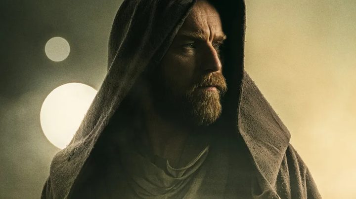 A hooded Obi-Wan with Tatooine's suns in the background.