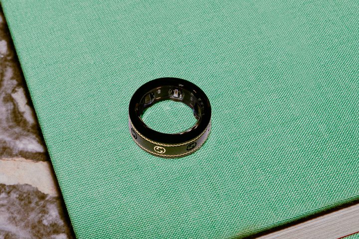 The Oura x Gucci Ring on a green table.