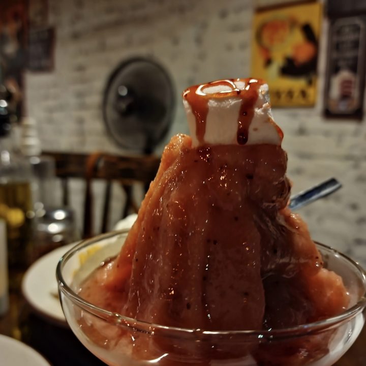 Unedited image of bubblegum granita topped with mashmallow and syrup in a glass cup shot on the Samsung Galaxy S22 Ultra in RAW.