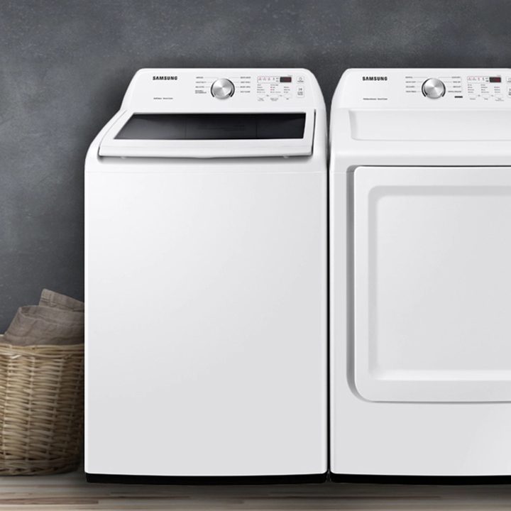 Samsung top-load washer and dryer set in white against a taupe background.