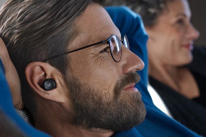 Man wearing Sennheiser TV Clear earbuds.