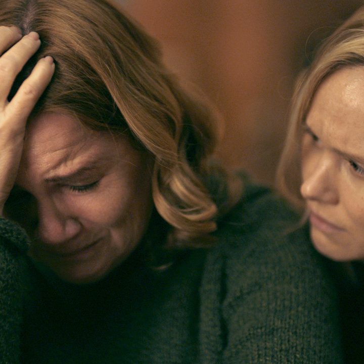 Yoli consoles a crying Lottie from behind in a scene from All My Puny Sorrows.