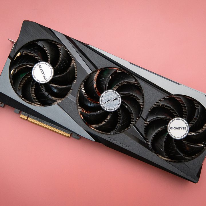 AMD RX 6950 XT graphics card on a pink background.