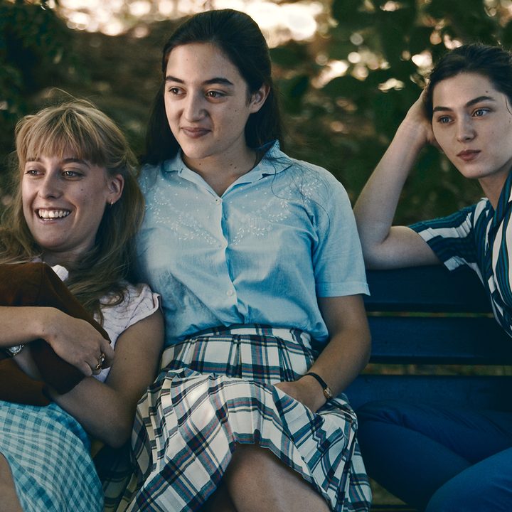 Anne sits with two of her friends on a bench in Happening.