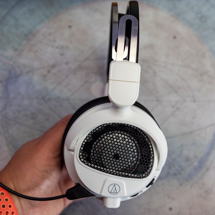 Audio-Technica ATH-GDL3 open-back gaming headphones being held by a hand.