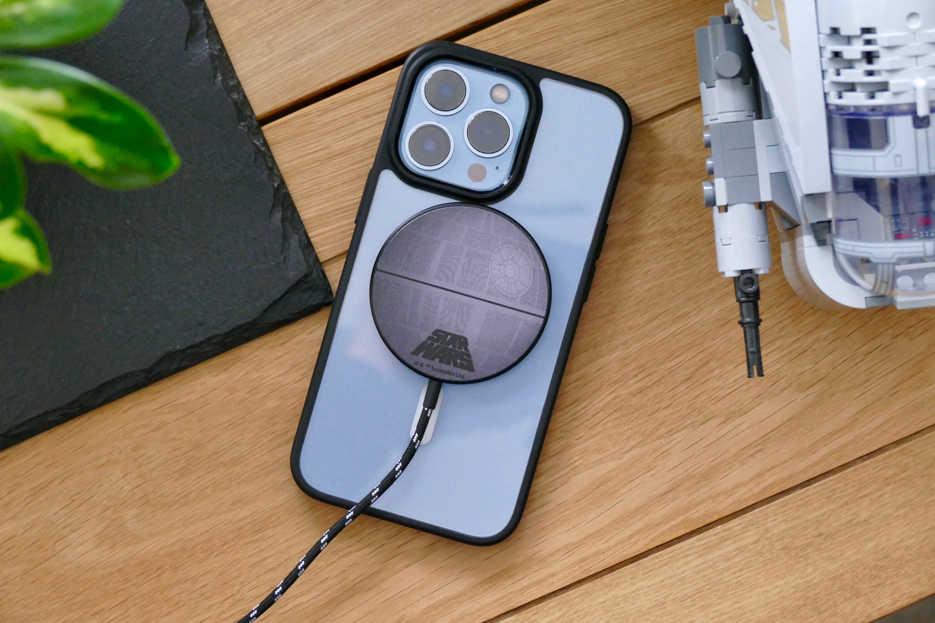 Casetify's Death Star magnetic charger on the back of an iPhone 13 Pro.