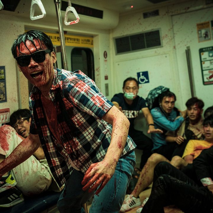 A crazed man stands covered in blood on a subway in The Sadness.