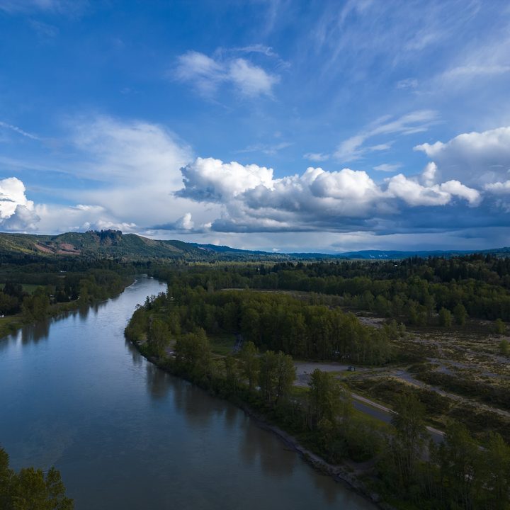 A river running through forests and fields.