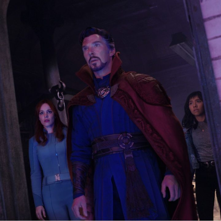 Rachel McAdams, Benedict Cumberbatch, and Xochitl Gomez look out a doorway i a scene from Doctor Strange in the Multiverse of Madness.