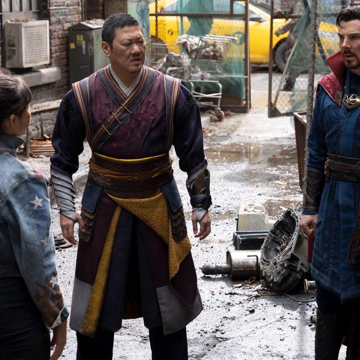 Xochitl Gomez, Benedict Wong, and Benedict Cumberbatch stand on a street in a scene from Doctor Strange in the Multiverse of Madness.