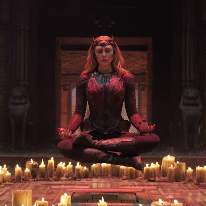 Elizabeth Olsen as Scarlet Witch levitates in a circle of candles.