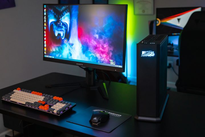 The Falcon Northwest Tiki set up next to a gaming monitor.