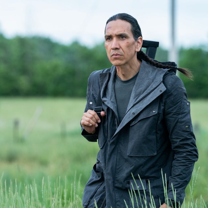Michael Greyeyes as John Rainbird walks through a field in a scene from Firestarter.