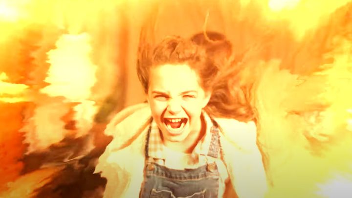 Ryan Kiera Armstrong screaming while surrounded by fire in Firestarter.