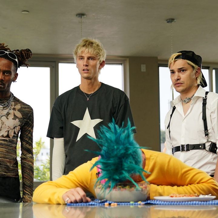 GaTa, Machine Gun Kelly, and Zach Villa look at Mod Sun on the table in a scene from Good Mourning.