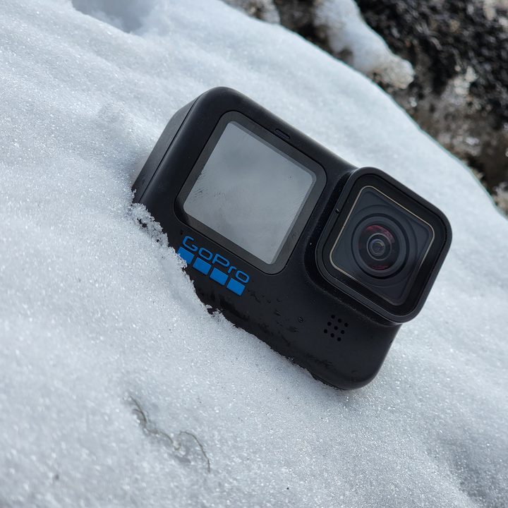 The GoPro Hero 10 Black in a snow bank.