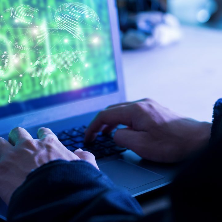 A depiction of a hacker breaking into a system via the use of code.