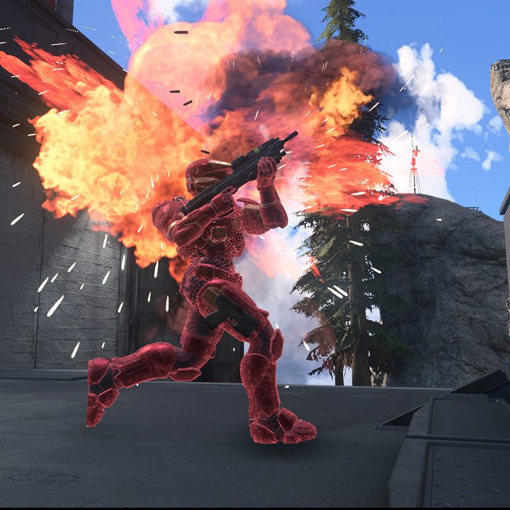 A Spartan fires a weapon with an explosion in the background.