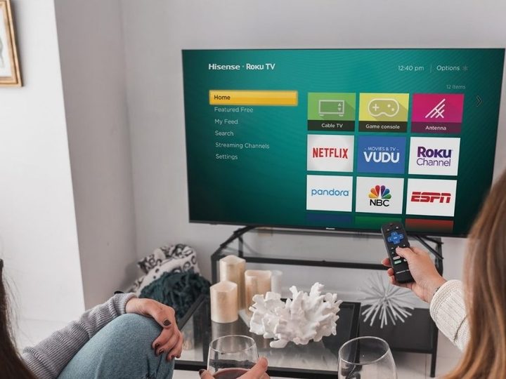 Hisense 75-inch 4K TV with remotes pointed at it.